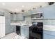 Charming kitchen with stainless steel appliances, and light blue cabinetry at 4967 Diana Dr, Indianapolis, IN 46203