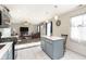 Modern kitchen seamlessly connects to a cozy living room, island, and stylish tile flooring at 4967 Diana Dr, Indianapolis, IN 46203