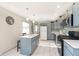 Updated kitchen with a central island, stainless steel microwave, and stylish marble floors at 4967 Diana Dr, Indianapolis, IN 46203