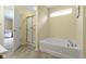Modern bathroom with tub, shower, and access to bedroom at 5145 Greenside Dr, Indianapolis, IN 46235