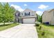 Charming two-story home featuring a two-car garage, well-manicured lawn, and inviting curb appeal at 5145 Greenside Dr, Indianapolis, IN 46235