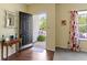 Welcoming foyer featuring hardwood floors, a view of the front yard, and stylish decor at 5145 Greenside Dr, Indianapolis, IN 46235
