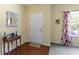 Cozy foyer area with wood floors, decorative mirror, and a glimpse into the living space at 5145 Greenside Dr, Indianapolis, IN 46235