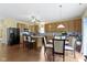Bright kitchen with stainless steel appliances, a center island, and an eat-in dining area at 5145 Greenside Dr, Indianapolis, IN 46235