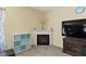 Cozy living room with a fireplace, a modern television, and neutral carpet at 5145 Greenside Dr, Indianapolis, IN 46235