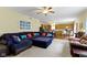 Bright living room with a sectional couch, showing an open floor plan to the kitchen area at 5145 Greenside Dr, Indianapolis, IN 46235