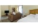 Spacious main bedroom features sitting area, tv and natural light at 5145 Greenside Dr, Indianapolis, IN 46235
