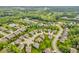 An elevated view of a residential area with verdant tree coverage, a small lake, and well-spaced homes at 532 Amersham Ct, Avon, IN 46123