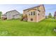 Spacious backyard featuring a well-maintained lawn and a two-story home with wood deck and stairs at 532 Amersham Ct, Avon, IN 46123