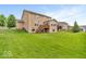 Lush backyard with expansive lawn, wood deck and patio, perfect for outdoor entertaining and relaxation at 532 Amersham Ct, Avon, IN 46123