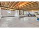 Unfinished basement with concrete flooring, exposed wood ceiling and wrapped walls with windows at 532 Amersham Ct, Avon, IN 46123