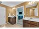 Bathroom featuring a double sink vanity, tile floor, and a door to an adjacent room at 532 Amersham Ct, Avon, IN 46123