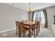 Dining room with a wooden table, seating for eight, neutral walls, and window with curtains at 532 Amersham Ct, Avon, IN 46123