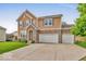 Charming two-story home with manicured lawn, stone accents, and three-car garage at 532 Amersham Ct, Avon, IN 46123