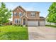 Charming two-story home with well-maintained lawn and a two-car attached garage on a sunny day at 532 Amersham Ct, Avon, IN 46123