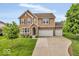 Charming two-story home with a stone and siding exterior, a well-manicured lawn, and a spacious driveway at 532 Amersham Ct, Avon, IN 46123