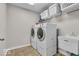 This spacious laundry room features white appliances and tile flooring at 532 Amersham Ct, Avon, IN 46123