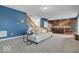 Living room with stairs, hardwood flooring, and view into modern kitchen at 532 Amersham Ct, Avon, IN 46123