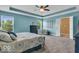 Spacious main bedroom featuring a tray ceiling, ceiling fan, and an ensuite bathroom at 532 Amersham Ct, Avon, IN 46123