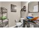 Stylish powder room featuring a unique sink, modern fixtures, and decorative shelving at 532 Amersham Ct, Avon, IN 46123