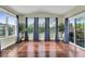 Bright sunroom offering hardwood floors, large windows, and access to the outdoor deck at 532 Amersham Ct, Avon, IN 46123