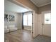 Bright foyer boasts wood floors and a white front door adjacent to a cozy living area at 548 Gosford Ct, Westfield, IN 46074