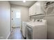 Bright laundry room equipped with modern washer, dryer, and cabinet storage at 548 Gosford Ct, Westfield, IN 46074