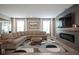 Inviting living room with wood floors, a large sectional sofa, and modern entertainment center at 548 Gosford Ct, Westfield, IN 46074