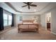 Large main bedroom with tray ceilings, carpet, and natural light at 548 Gosford Ct, Westfield, IN 46074