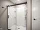 Modern shower with sliding glass doors and built-in shelves at 548 Gosford Ct, Westfield, IN 46074