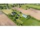 Aerial view of a home, barn, and fields, with trees and other houses nearby at 5480 E County Rd 800 N, Brownsburg, IN 46112