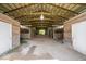 Spacious barn interior featuring horse stalls with wood framing and a central aisle at 5480 E County Rd 800 N, Brownsburg, IN 46112