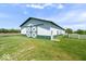Large white barn with green trim, set in a grassy field under a clear blue sky at 5480 E County Rd 800 N, Brownsburg, IN 46112