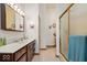 Well-lit bathroom features a dual-sink vanity, a glass-enclosed shower, and tile flooring, maximizing functionality and style at 5480 E County Rd 800 N, Brownsburg, IN 46112