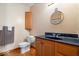 Traditional bathroom with a wood vanity, dark sink, and a wall-mounted cabinet providing practical storage solutions at 5480 E County Rd 800 N, Brownsburg, IN 46112