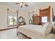 Spacious bedroom features a four-poster bed, large windows and decorative molding, offering a warm, traditional aesthetic at 5480 E County Rd 800 N, Brownsburg, IN 46112