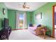 Bright bedroom with a ceiling fan, large window, and sitting area offering natural light and comfortable living at 5480 E County Rd 800 N, Brownsburg, IN 46112