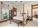 A well-lit main bedroom with a four-poster bed, a chest of drawers, and hardwood trim at 5480 E County Rd 800 N, Brownsburg, IN 46112