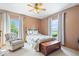 Comfortable bedroom featuring a decorative bed, wood chest, and natural light from the dual windows at 5480 E County Rd 800 N, Brownsburg, IN 46112