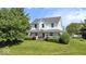 Inviting two-story home with a charming wrap-around porch, manicured lawn, and mature landscaping at 5480 E County Rd 800 N, Brownsburg, IN 46112