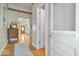 Hallway with hardwood floors, decorative trim and a view through an open doorway of the home's entry at 5480 E County Rd 800 N, Brownsburg, IN 46112