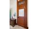 Close up of a vintage door with decorative glass, complemented by an antique side table and ornate trim at 5480 E County Rd 800 N, Brownsburg, IN 46112