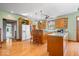 Open kitchen with wood floors, island seating, and abundant natural light at 5480 E County Rd 800 N, Brownsburg, IN 46112