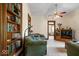 Cozy living room featuring carpet, a ceiling fan, and built-in shelving at 5480 E County Rd 800 N, Brownsburg, IN 46112