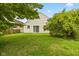 The home has a private backyard with a green lawn, mature trees, and a patio area at 5503 Wilder Way, Indianapolis, IN 46216