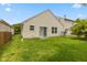 The home features a private yard, mature trees, an AC unit, and a sliding glass door at 5503 Wilder Way, Indianapolis, IN 46216
