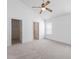 Bright bedroom featuring a ceiling fan, neutral carpet, and direct access to the closet and bathroom at 5503 Wilder Way, Indianapolis, IN 46216