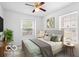 Bright bedroom featuring a bed with neutral tones, two windows, and a ceiling fan at 5503 Wilder Way, Indianapolis, IN 46216