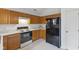 Cozy kitchen features white countertops, black appliances, and light wood cabinets for ample storage and a functional layout at 5503 Wilder Way, Indianapolis, IN 46216