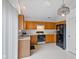 Functional kitchen with oak cabinets, white countertops, black appliances, and ample storage space, perfect for everyday cooking at 5503 Wilder Way, Indianapolis, IN 46216